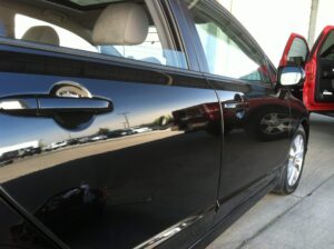 A typical door ding in the passenger rear door of a sedan